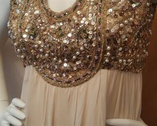 DETAIL OF JEWELED GOWN