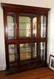 Beautiful extra large curio cabinet, glass shelves, mirrored back, lighted, nice carved detail
