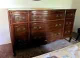 Vintage (1930's or 40's) Dark Walnut triple dresser, bow front, original brass hardware, relief carved, custom cut glass top.