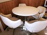 Retro dinette set. Round white laminate table, aluminum pedestal base, 4 matching white vinyl with black piping swivel tub chairs on wheels (one chair needs repair to base and one has a split in the vinyl).