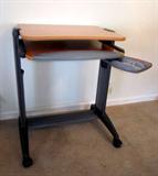 Computer stand with keyboard and mouse shelf pullouts by Actiu (made in Spain).