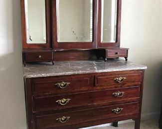 Beautiful marble topped dresser.  Has two matching night stands and a headboard.  