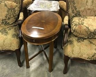 SMALL OVAL WALNUT INLAID BURLED TABLE 125.00 IT HAS A PULL OUT SHELF FOR YOUR DRINK