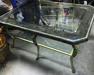 DESIGNER HEAVY BIG COFFEE TABLE WITH BRASS LIONS HEADS, INLAID BEVELED GLASS, WITH GLASS SHELF ALSO. ONE TIME OFFER OF $350.00 REALLY A STEEL OF A DEAL FOLKS
