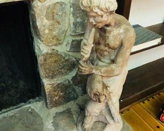 Wood sculpture of Pan the flute player