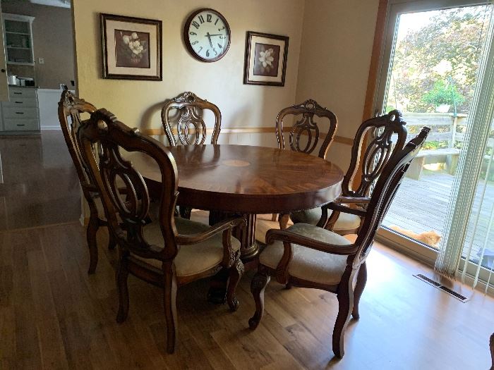 Round dining room table with six captain's chairs