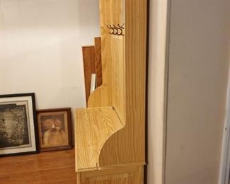 Seat opens for storage, hooks for coats, etc., Mirror at top. Great condition.