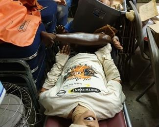 Anatomical lifesaving training manniquens with gurney, boxes and cases of spare body parts and pieces for teaching purposes. Some are electronic and some are air pressure filled.