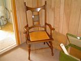 antique oversize cane seat armchair