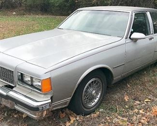 At 8PM: 1986 Chevy Caprice Classic Estate Auto, Brougham Edition; Gray Exterior with Burgundy Pinstripe Detail; Luxe Burgundy Velour Interior; Power Windows, Locks, Driver's Seat; AM/FM Radio with Cassette Player; Air Conditioning; V8 5.0L Engine. VIN: 1G1BN69H3GY106498
Vehicle Terms:
- Vehicles are sold AS IS, in AS FOUND/ESTATE condition.
- Minimum of 10% deposit due on day of auction (Cash, Check, VISA, MC, or Debit).
- Balance paid in full by Thursday following (Cash or Certified Bank Check ONLY).