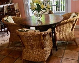 Round copper top table with iron base offered by Susie's Key West Estate Sales
