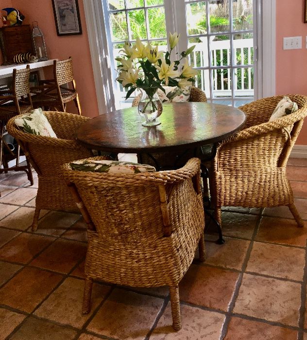 Round copper top table with iron base offered by Susie's Key West Estate Sales