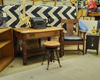 black & white pattern rug,   antique desk, chair, and piano stool