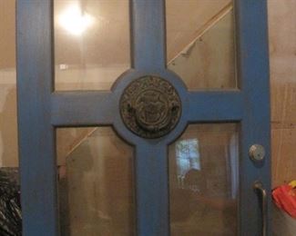 Quality door with glass panels and ornate knocker.