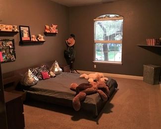 Queen sized low bed with attached night stands.  dresser.  miscellaneous pictures.