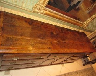 Offered at $7000. Oak six drawer plus two door North Wales dresser base. Superb example of the classic late 18th century North Wales cupboard dresser base, circa 1790. Excellent top with banded edges. Two rows of four drawers, three top drawers, plus two cupboard doors in the center with attractive shaped panels. Excellent color and condition, cleaned and waxed. (22"d x 76.75"l x 31"h) ~ Please send inquiries via text to 251.525.0966 and reference the photo number.