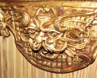 Offered at $6900.  French gilt carved wood mirror with cherub and "winds of time" carvings. Approx. 1790 era. Some slight cracking expected with age of piece, and easily repairable. (84" x 52") ~ Please send inquiries via text to 251.525.0966 and reference the photo number. 