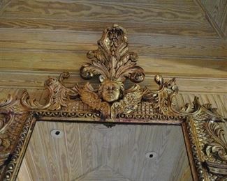 Offered at $6900.  French gilt carved wood mirror with cherub and "winds of time" carvings. Approx. 1790 era. Some slight cracking expected with age of piece, and easily repairable. (84" x 52") ~ Please send inquiries via text to 251.525.0966 and reference the photo number. 