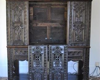 Offered at $2600.  French Revival cupboard in carved Oak in the style of Louis XIII. Ebonized finish. Some damage to doors as shown. (83"h x 22"d x 69"w) ~ Please send inquiries via text to 251.525.0966 and reference the photo number.  