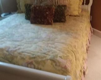White, wood queen bed with beautiful bedding and matching shower curtain