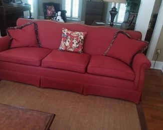 One of two full red couches