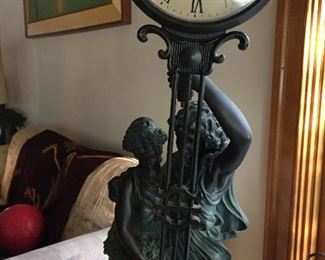                          STATUE HOLDING A CLOCK