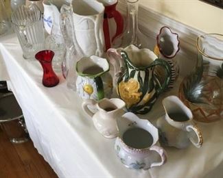 Many pitchers including some hand-painted china.
