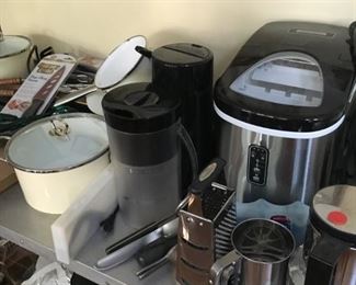 Sets of pots, small ice machine, toaster oven and other kitchen items.