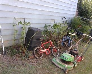Lawn mowers (as is) ,bicycles, Rubbermaid storage cabinet