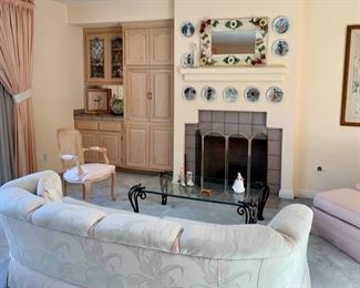 Artisan "Floral" Mirror; Curved Sofa; Club-chair & Ottoman; Louis XVI "style" Fauteuil around an Iron & Beveled Glass Cocktail Table