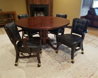 Reversible Game Table/Dining Table with four rolling chairs. Table top can be flipped over (there is another picture that shows what it looks like) for playing cards games, etc.