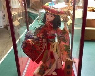 beautiful geisha girl in glass case