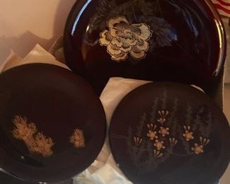 set of laquer plates - 1 large plate and 12 smaller plates.  Still wrapped from coming from Japan in mid 1950's
