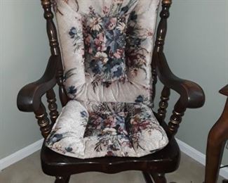 Wooden rocker with padding on back and seat