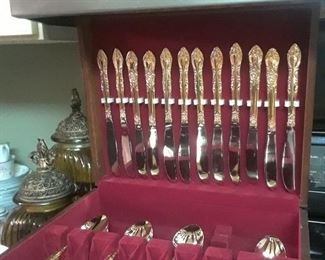 Three wood cases full of gold plated silverware