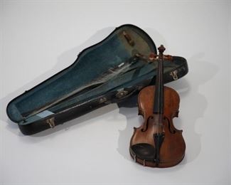 Violin, unmarked of typical shape and scroll tip.  Bow unmatched, new has hair strings.  Case unmatched, has black leather exterior, blue lining, three metal locks, three hinges.  Marked with label in interior compartment" TRADE MARK M    W  WARRENTED  REGISTERED  JULY 1893".   Restored in 1994. 