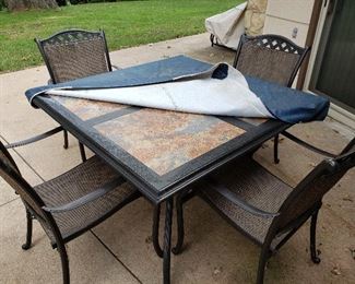 Iron and tile top patio table and four chairs