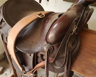 Western cowboy saddle with rifle scabbard. Over 65 years old and looks new