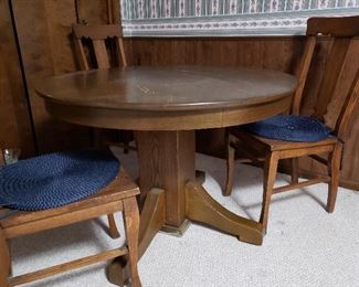 Heavy antique oak round dining table plus four chairs