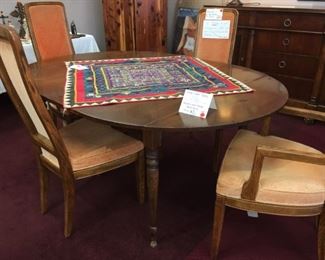 Nichols and Stone Furniture Co., drop-leaf table, 48" round, 26" drop-leaf with 2 10" leaves. Set of 4 (2 are arm chairs) mid-century Henredon upholstered dining chairs. On table: Vintage hand-stitched coverlet from Nepal, 37.5” square.