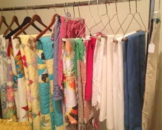 Assorted quilts and table cloths
