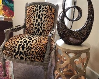 Leopard print chair, carved wooden table.