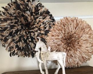Feathered wall decorations.  Carved horse
