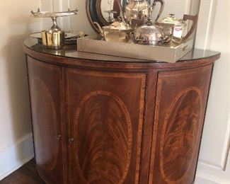 Antique half-moon table, glass top, with storage.