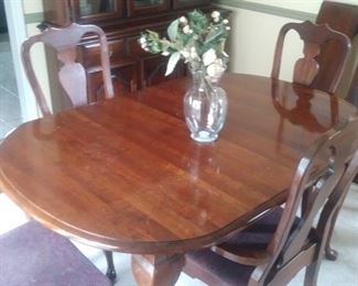 Cherry dining room table with  two leaves and six matching chairs
