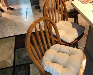Three matching oak swivel top Counter chairs