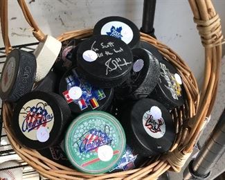Large collection of commemorative hockey pucks