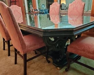 Mirror top covers three sections of an ornate dining table; six upholstered dining chairs add to the beauty of this piece