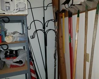 Shepherd's hooks, American flags, garden tools