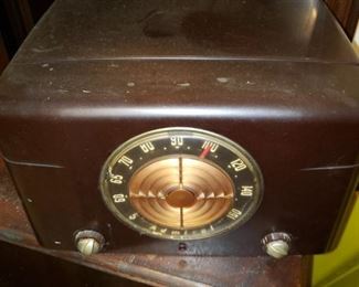 Antique Admiral radio/record player on top of antique record storage cabinet.